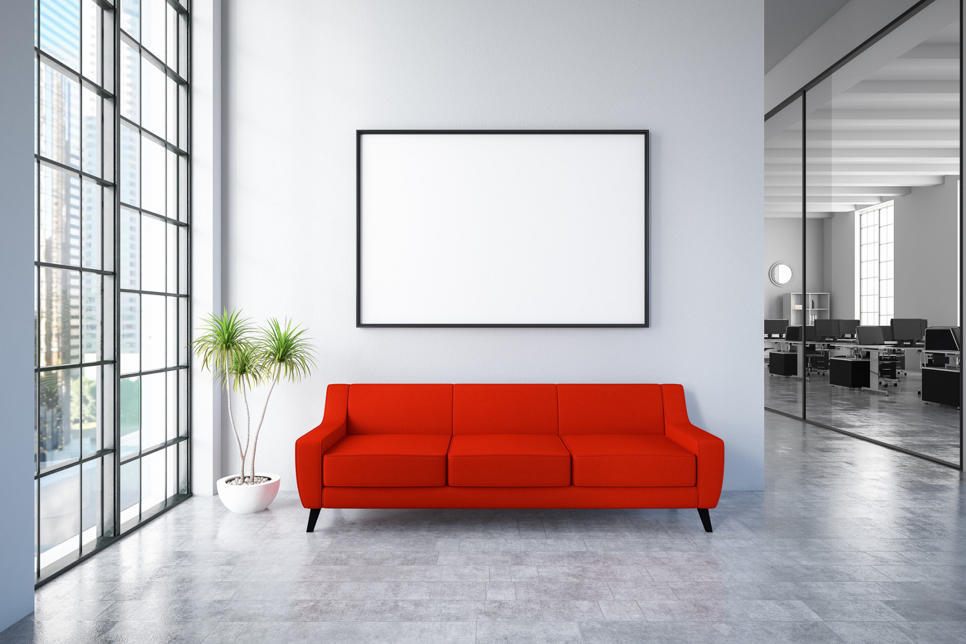 A red sofa beneath a large framed display in a modern office lobby